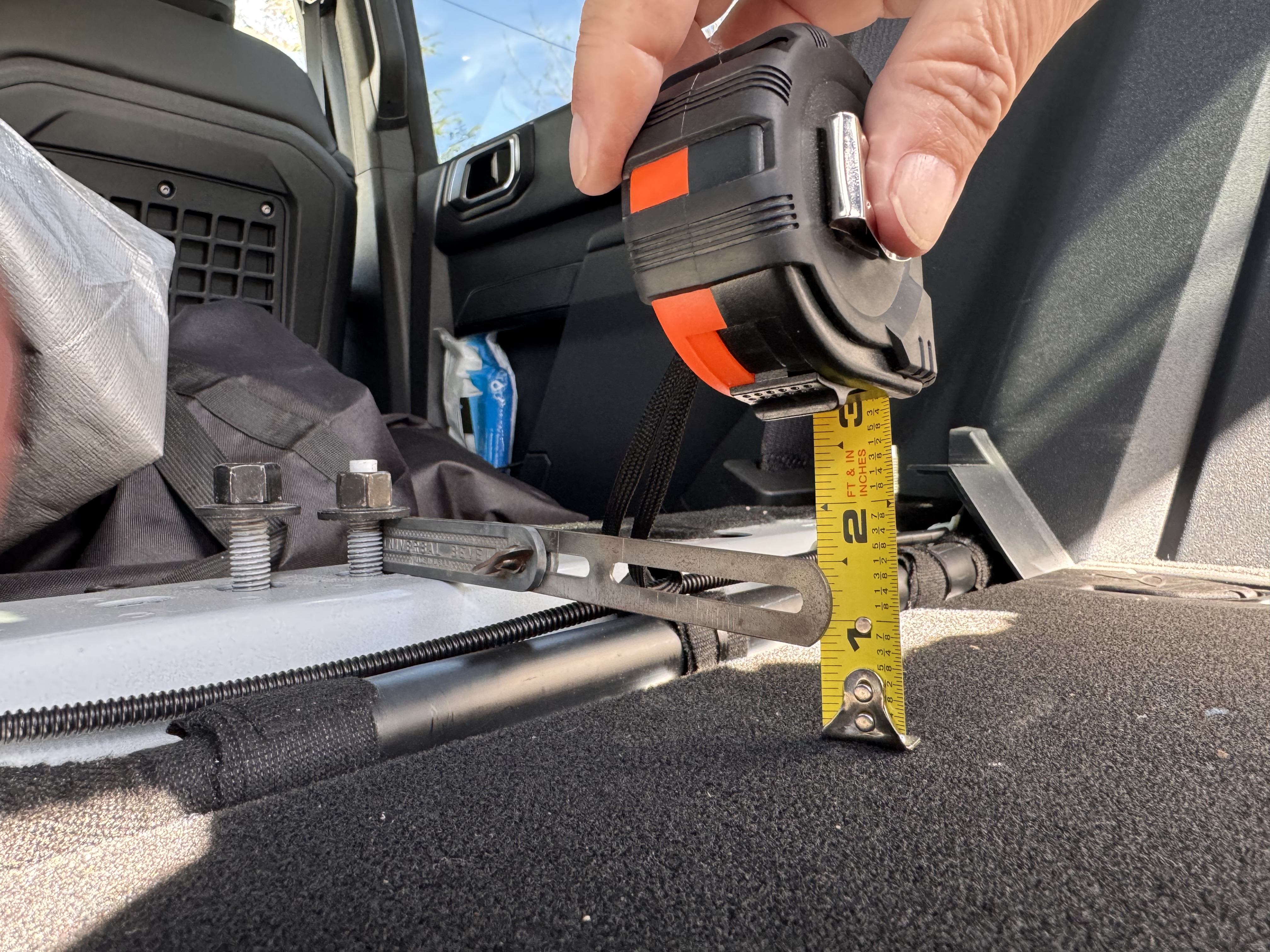 With the 4D back seat, delete your left with a hump and 2 bolts sticking up. Personally, I wouldn’t have a problem sawing off the two. Still leaves you with other bolts to reinstall the back seats. Would be easy to put other mounting in to replace the two you cut off. 